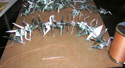 Stringing up the paper cranes
